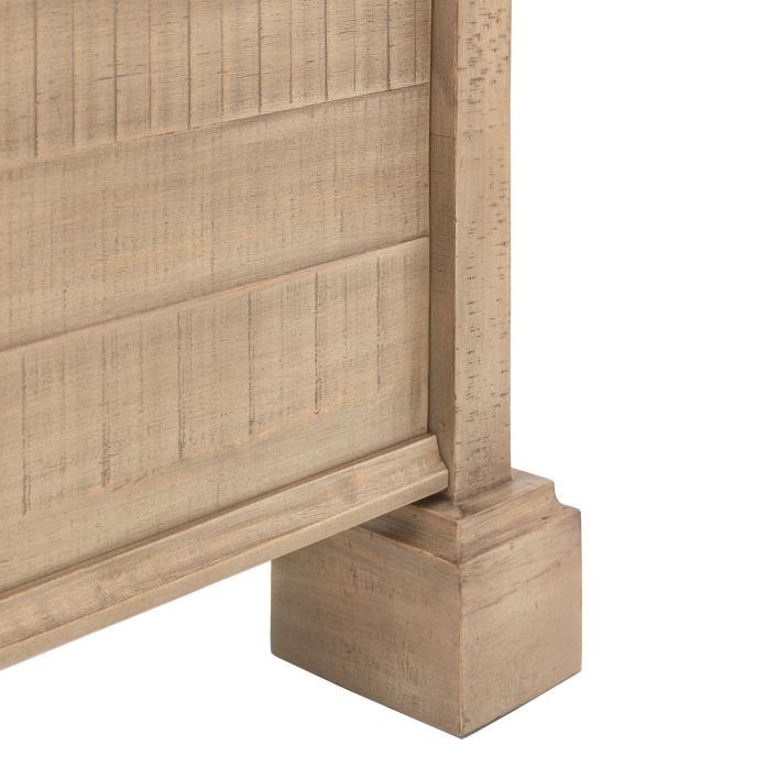 Close-up of the wooden footboard corner detail of the Vancouver 5' Bed, showcasing its textured and rustic light wood finish.