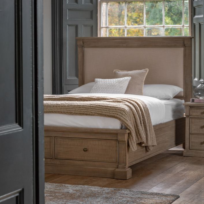 Vancouver 6' Bed in a classic wooden finish with an upholstered headboard, styled with neutral bedding and set in a cozy room.