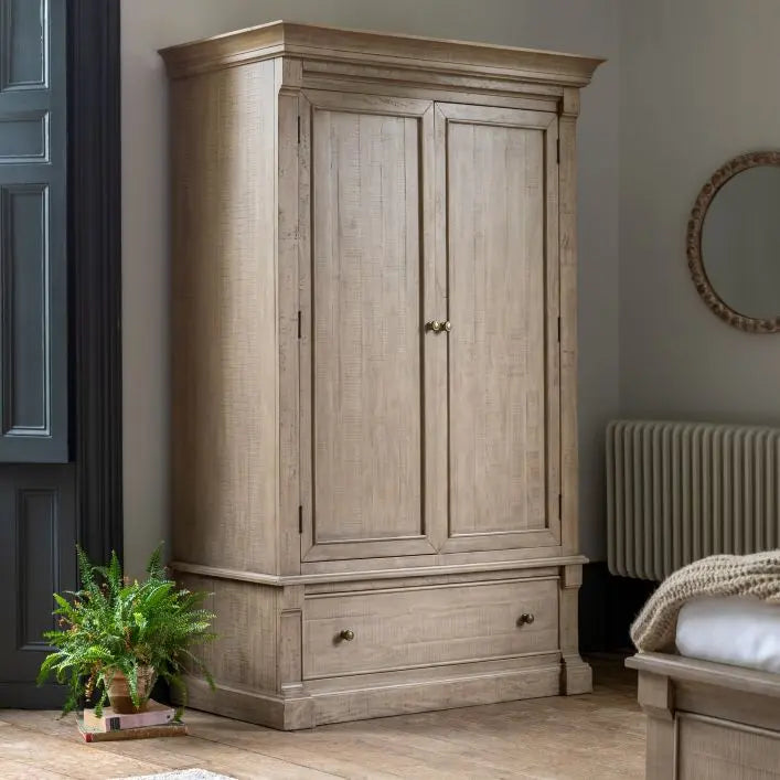 Vancouver 2 Door Wardrobe, 1400x650x2135mm, in a natural wood finish with two doors and a bottom drawer, placed in a cozy bedroom.