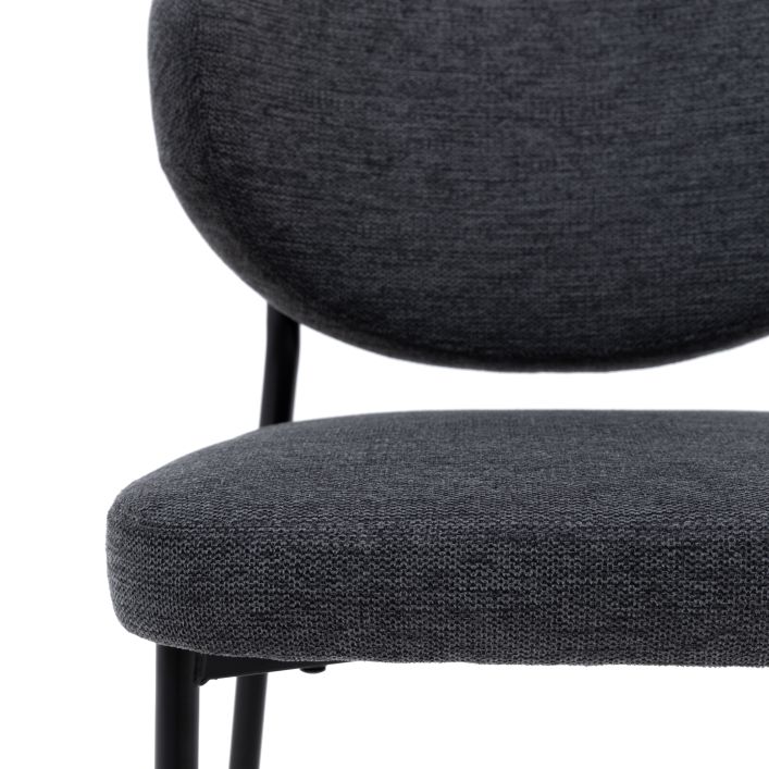 Close-up view of the Oppo Dining Chair in dark grey fabric upholstery, showcasing its cushioned seat and backrest with black legs.