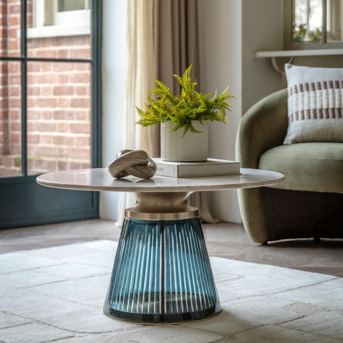 Seville Coffee Table in blue/green, 765x765x420mm, featuring a modern design with a glass base and round top in a cozy living room.