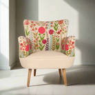 Floral-patterned armchair in a bright room with sunlight casting shadows.