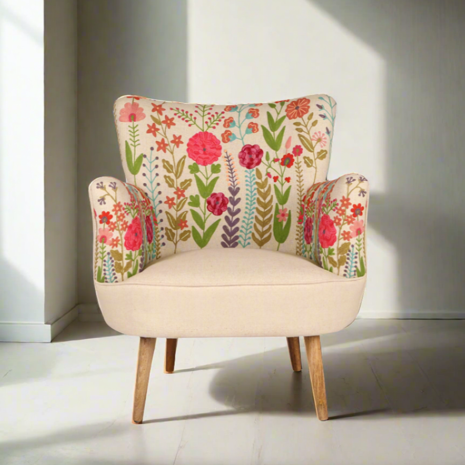Floral-patterned armchair in a bright room with sunlight casting shadows.