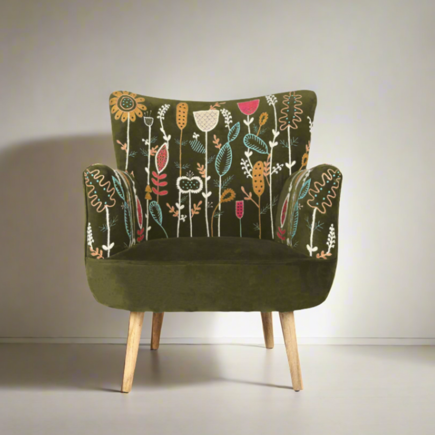 Green armchair with floral pattern on a plain background