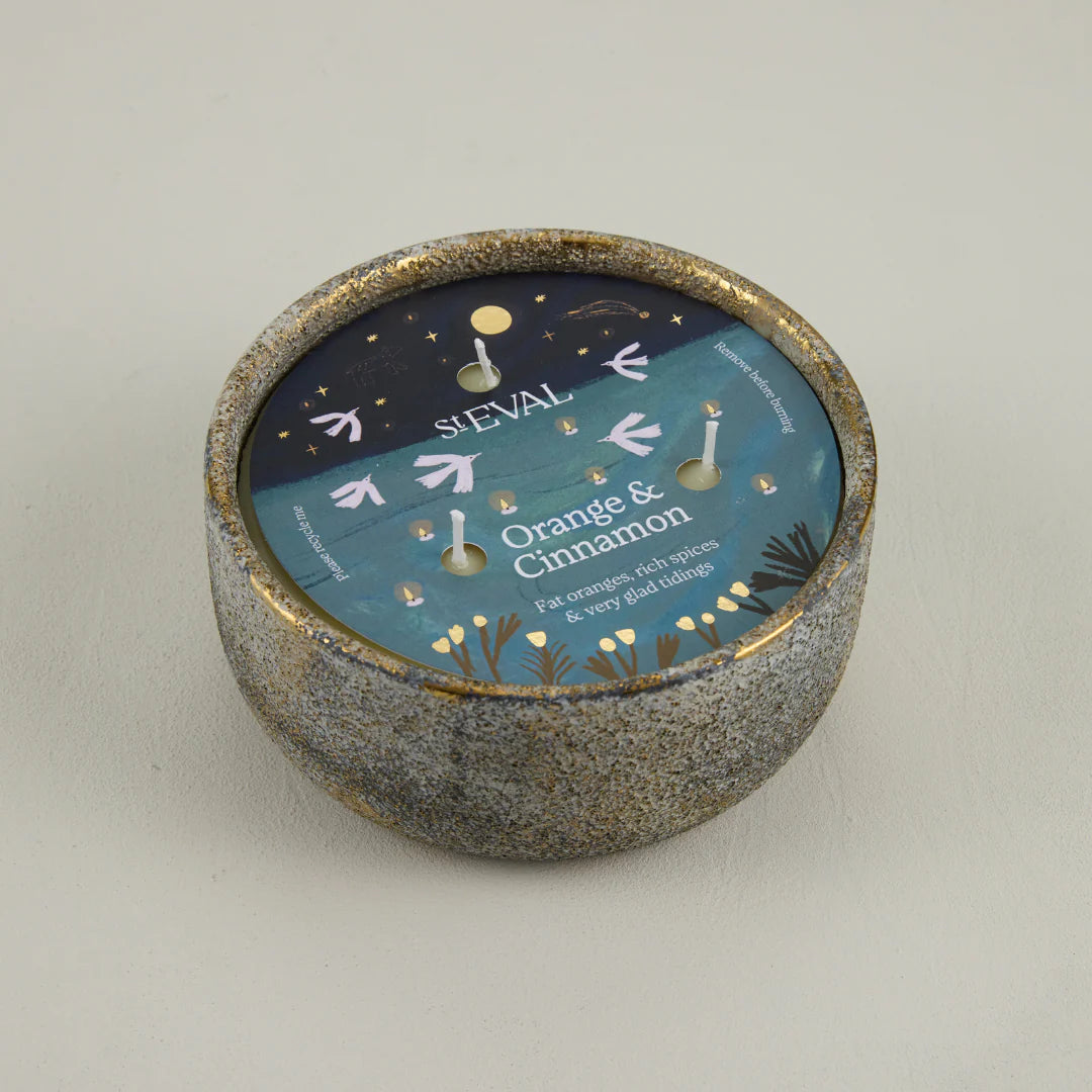 Sieval candle with 'Orange & Cinnamon' label on a plain background