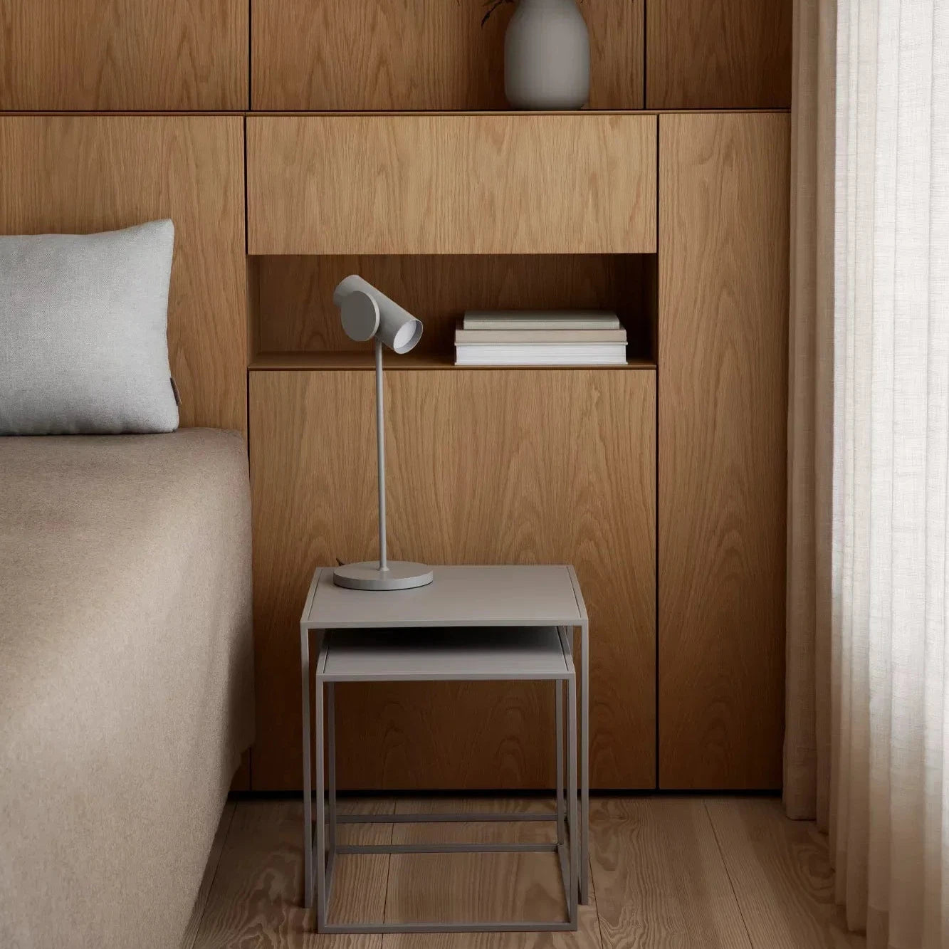 Modern bedroom with wooden wall panels, a bed, and minimal decor.