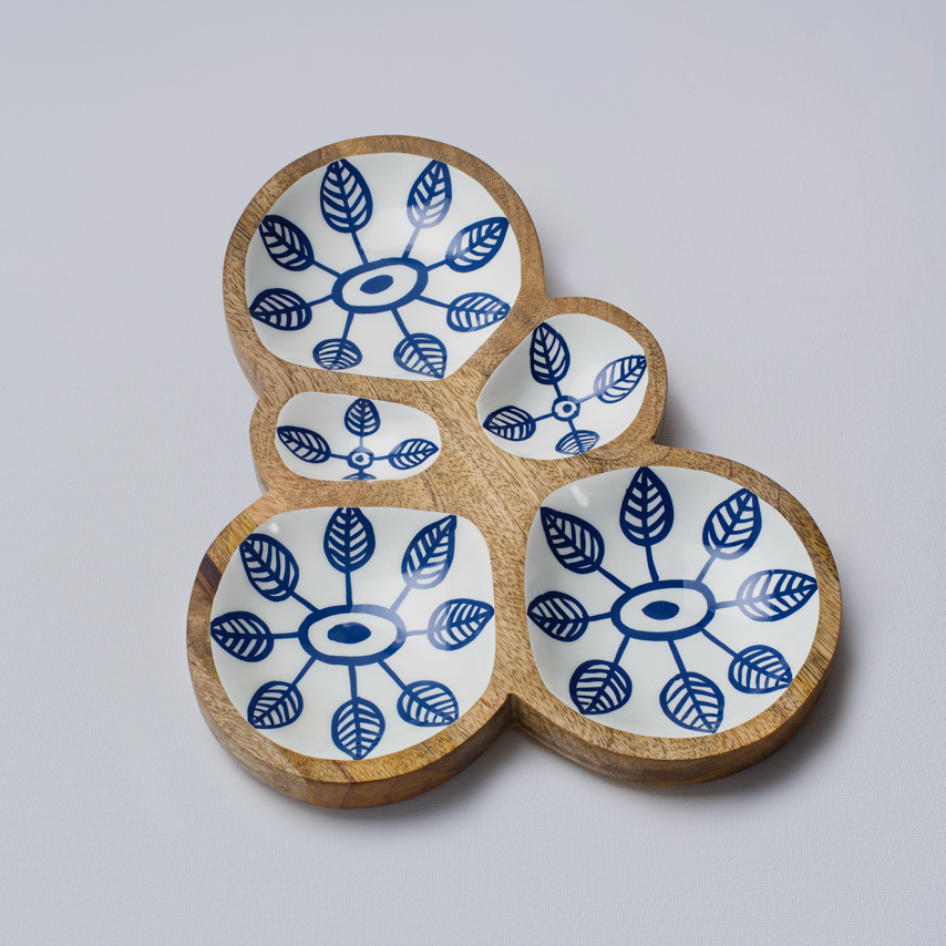 Set of four ceramic coasters with blue leaf patterns on a white background