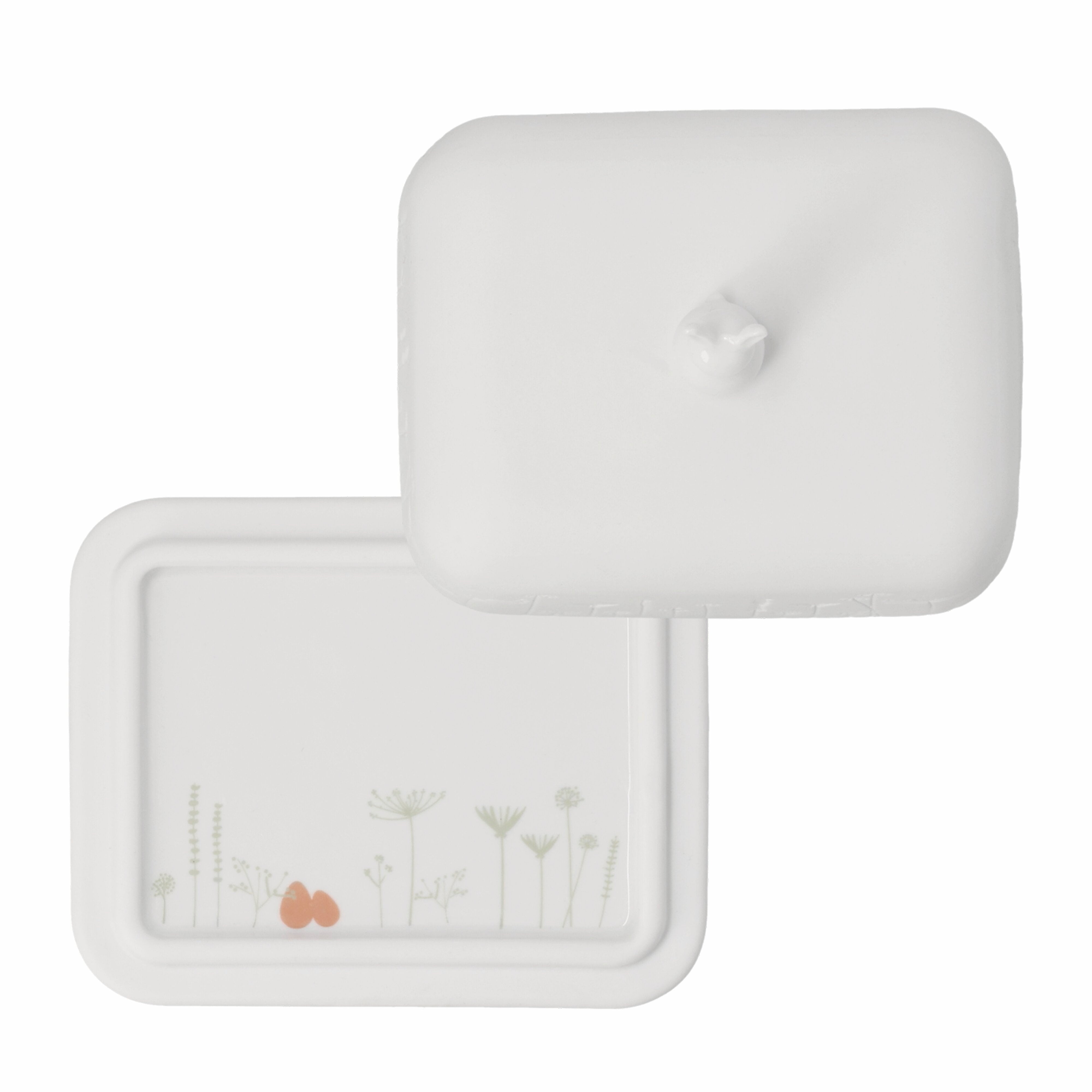 White soap dish with floral design and heart on a white background