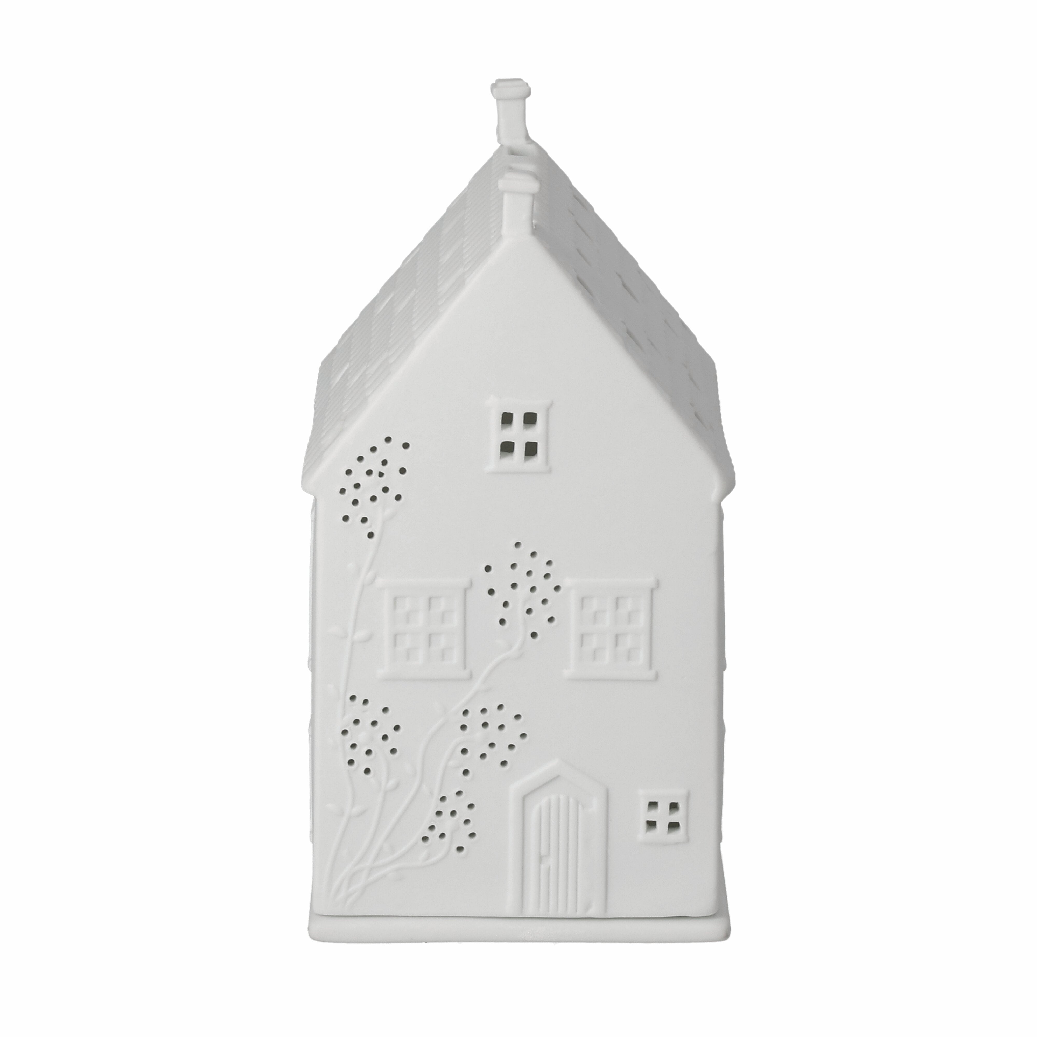 White ceramic house-shaped lantern with decorative patterns on a white background