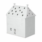 White house-shaped lantern with perforated design on a white background