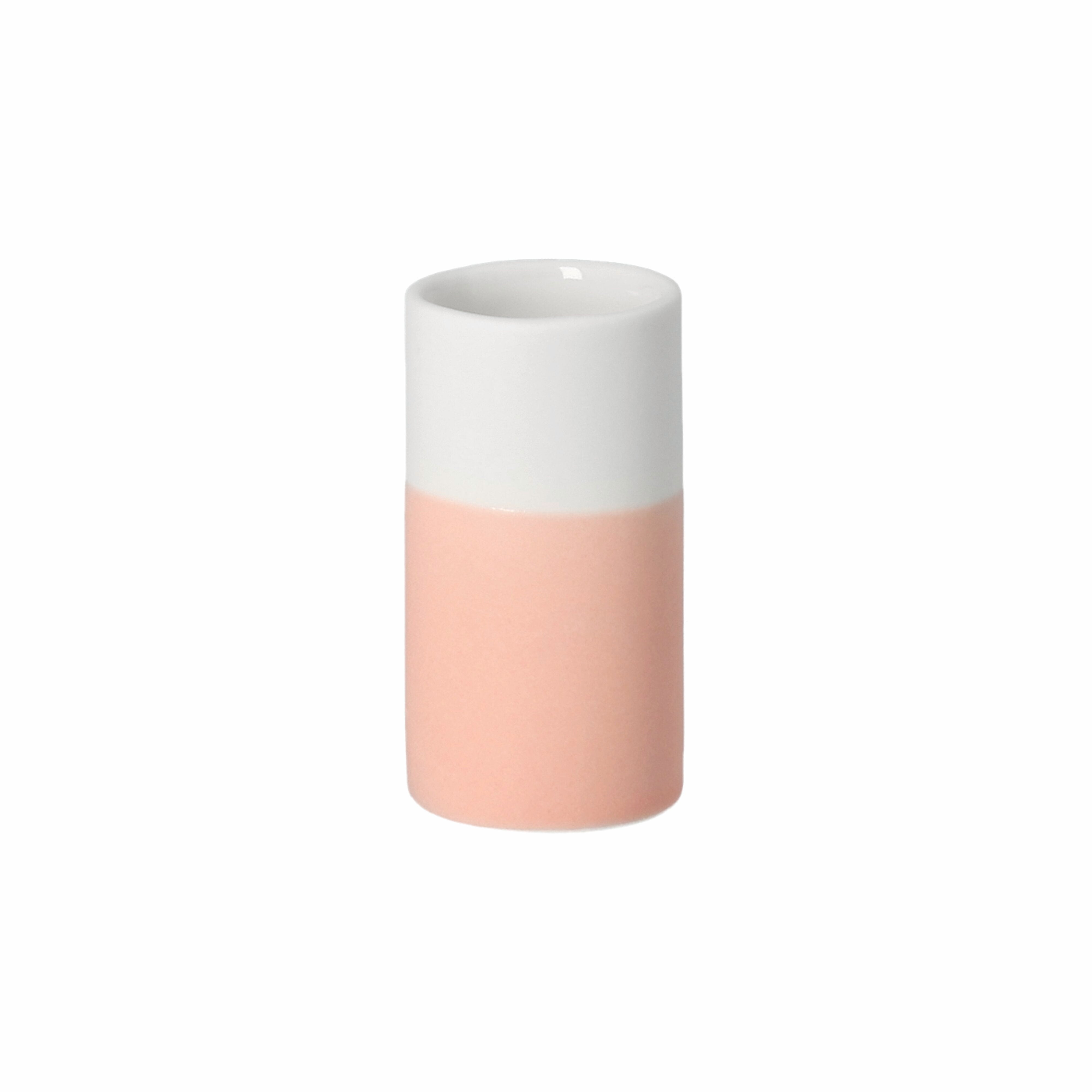 Two-toned pink and white cylindrical vase on a white background
