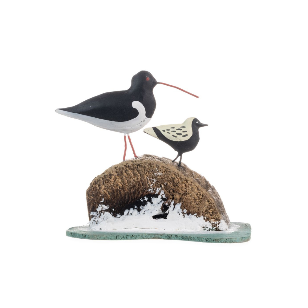 Decorative figurine of two birds on a rock with snow, on a white background