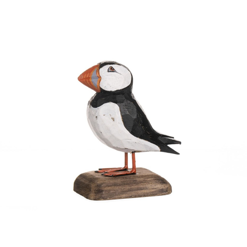 Wooden puffin figurine on a white background