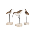 Three decorative bird figures on stands with a white background