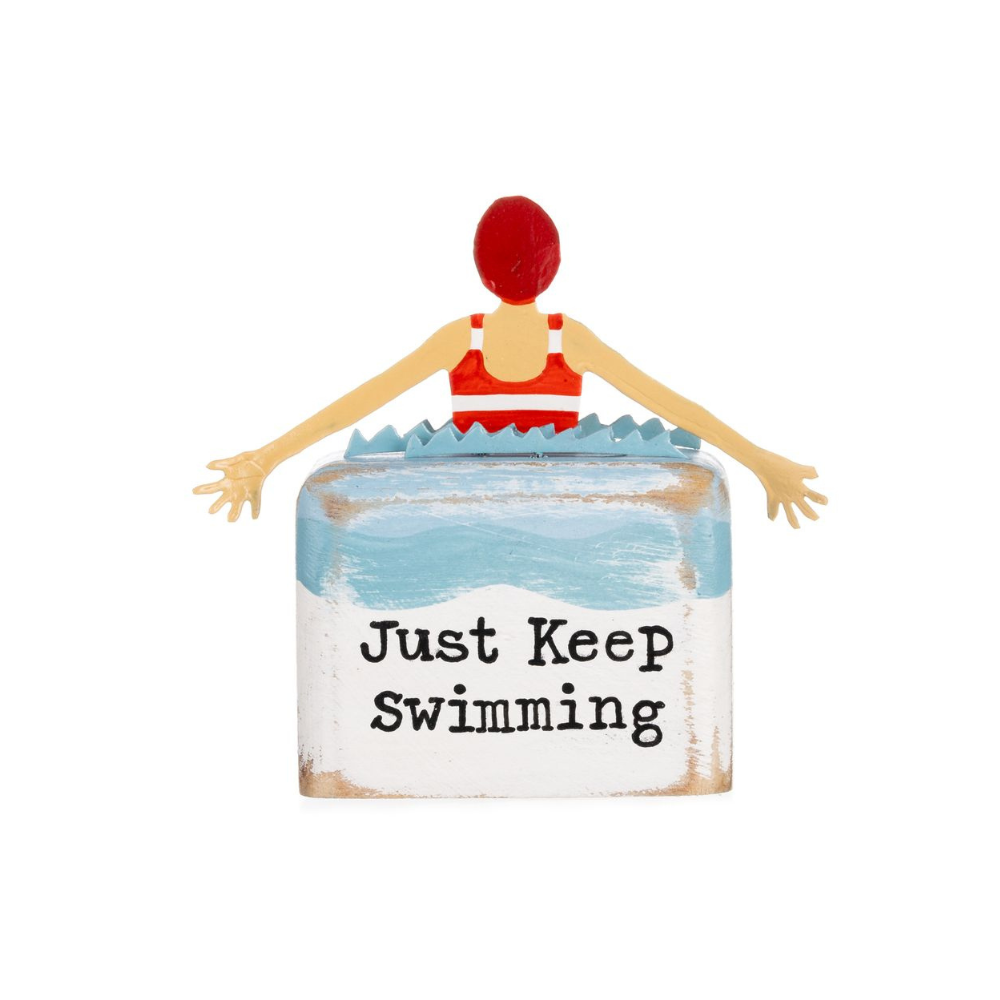 Decorative sign with a person in a swimsuit and 'Just Keep Swimming' text on a white background
