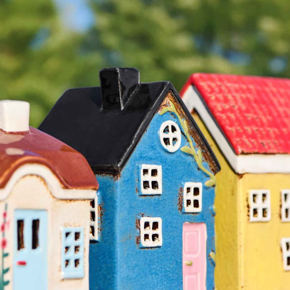 Colorful model houses with a blurred green background