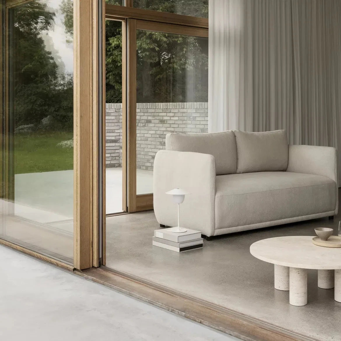Modern living room with a gray sofa, coffee table, and decorative items.