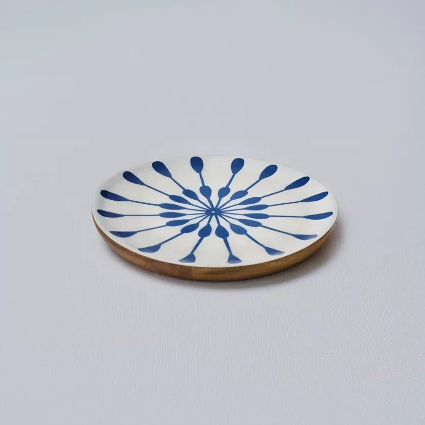 Ceramic coaster with blue abstract design on a white background