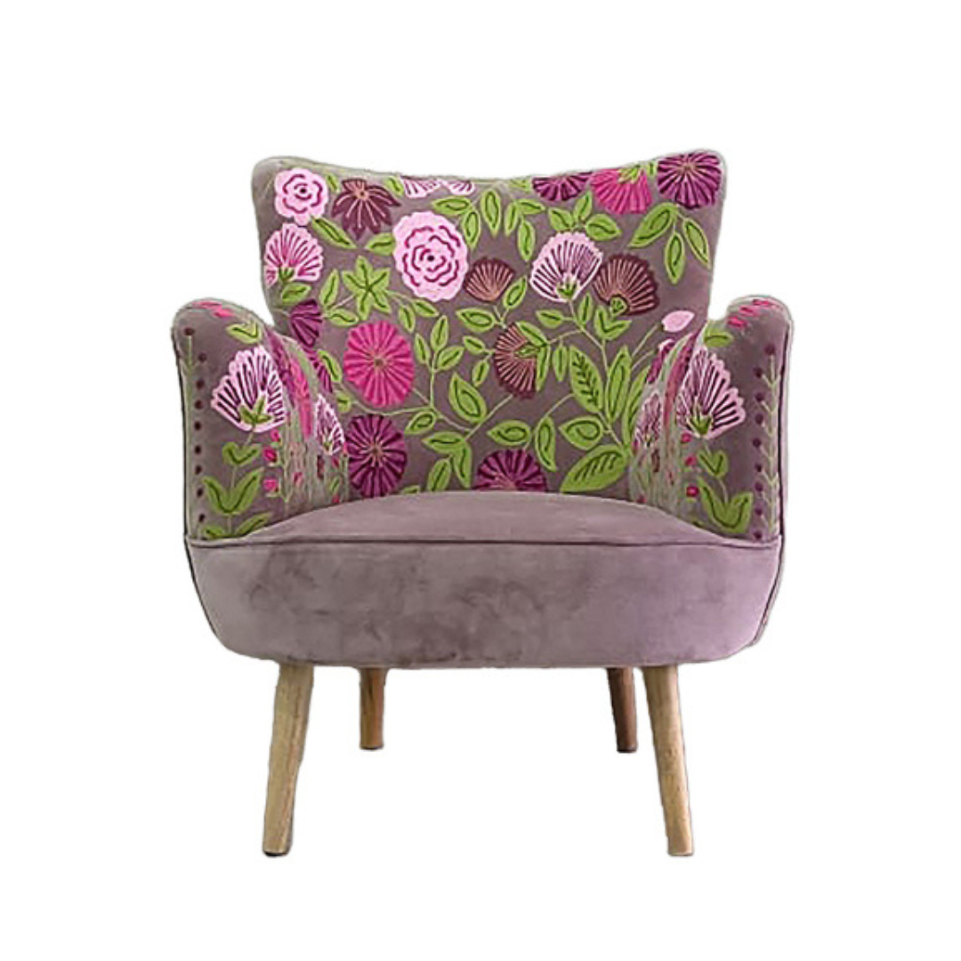Floral patterned armchair with a pink and green design on a white background
