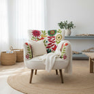 Decorative armchair with colorful floral and bird pattern on a white background