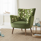 Amelia Heligan velvet armchair in moss green with embroidered floral pattern in a coastal inspired living room
