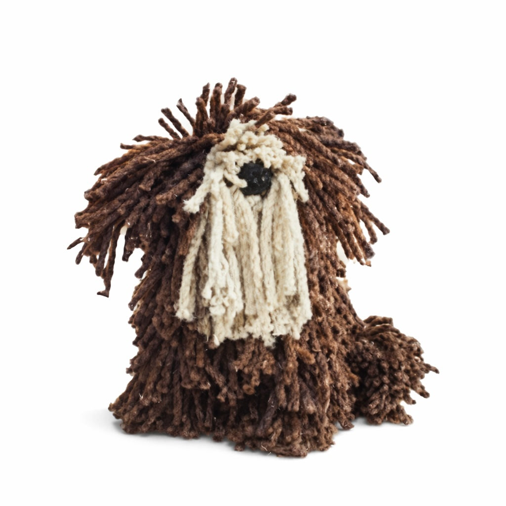 Plush toy resembling a dog with shaggy brown fur on a white background
