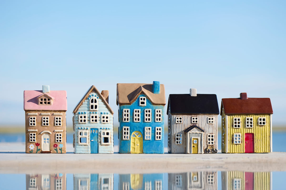 Five colourful Ib Laursen ceramic tealight houses with pink, blue, black and brown roofs